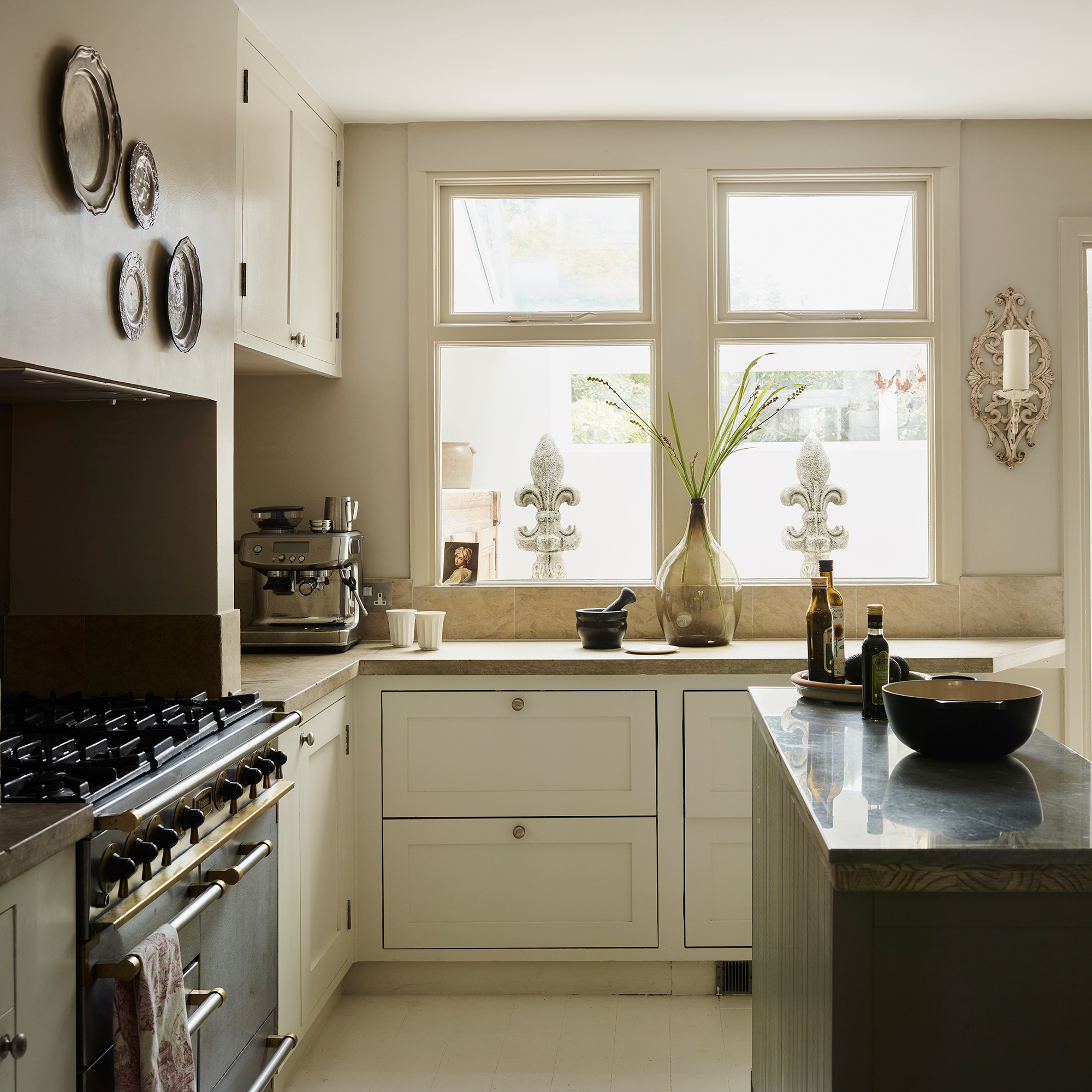 traditional cream kitchen with stone worktops and metal range cooker