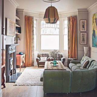 Living room with sage green sofa