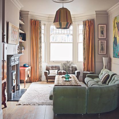 Living room with sage green sofa 