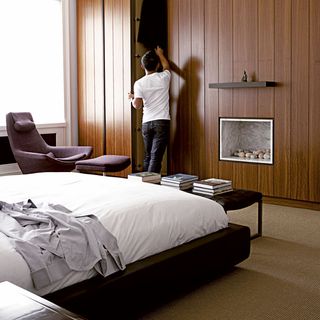 bedroom with wooden ceiling fitted cupboard and bed