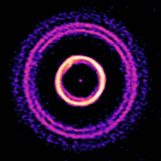 ALMA observation of the young star system HD 169142, which shows an outer region composed of thin rings and a double gap. These fine structures had never been seen before in the outer parts of a disk with a deep chasm that severs the protoplanetary environment into inner and outer regions. 