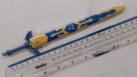 A small Master Sword replica compared against a ruler, measuring 6 inches.
