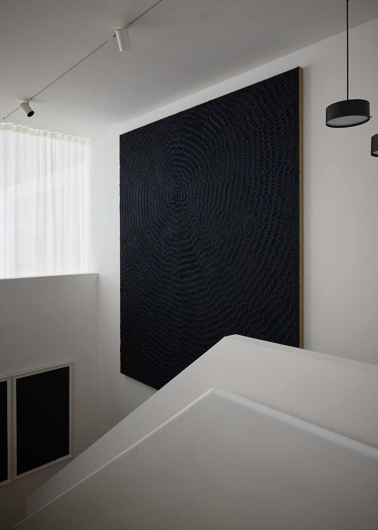 black painting on white staircase wall
