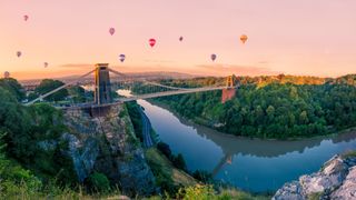 Collection of hot air balloons across Clifton Suspension Bridge in Bristol