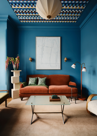 A terracotta sofa in a blue living room