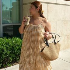 @marina_torres wears a yellow gingham midi dress