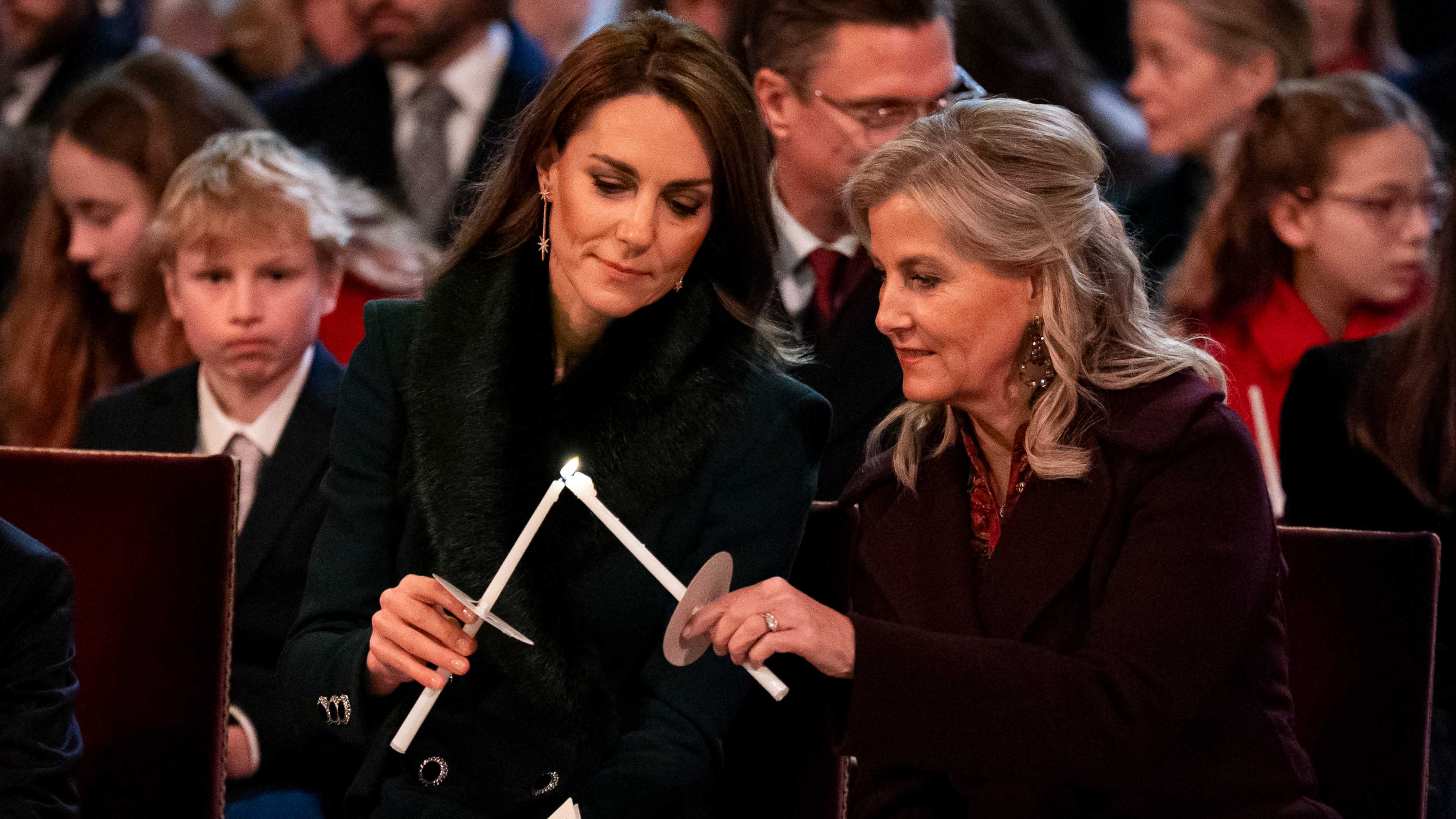 Catherine, Princess of Wales and Sophie, Duchess of Edinburgh light candles at the fifth annual "Together At Christmas" Carol Service" at Westminster Abbey in London on December 5, 2025
