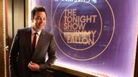 Jimmy Fallon next to The Tonight Show 10th Anniversary poster