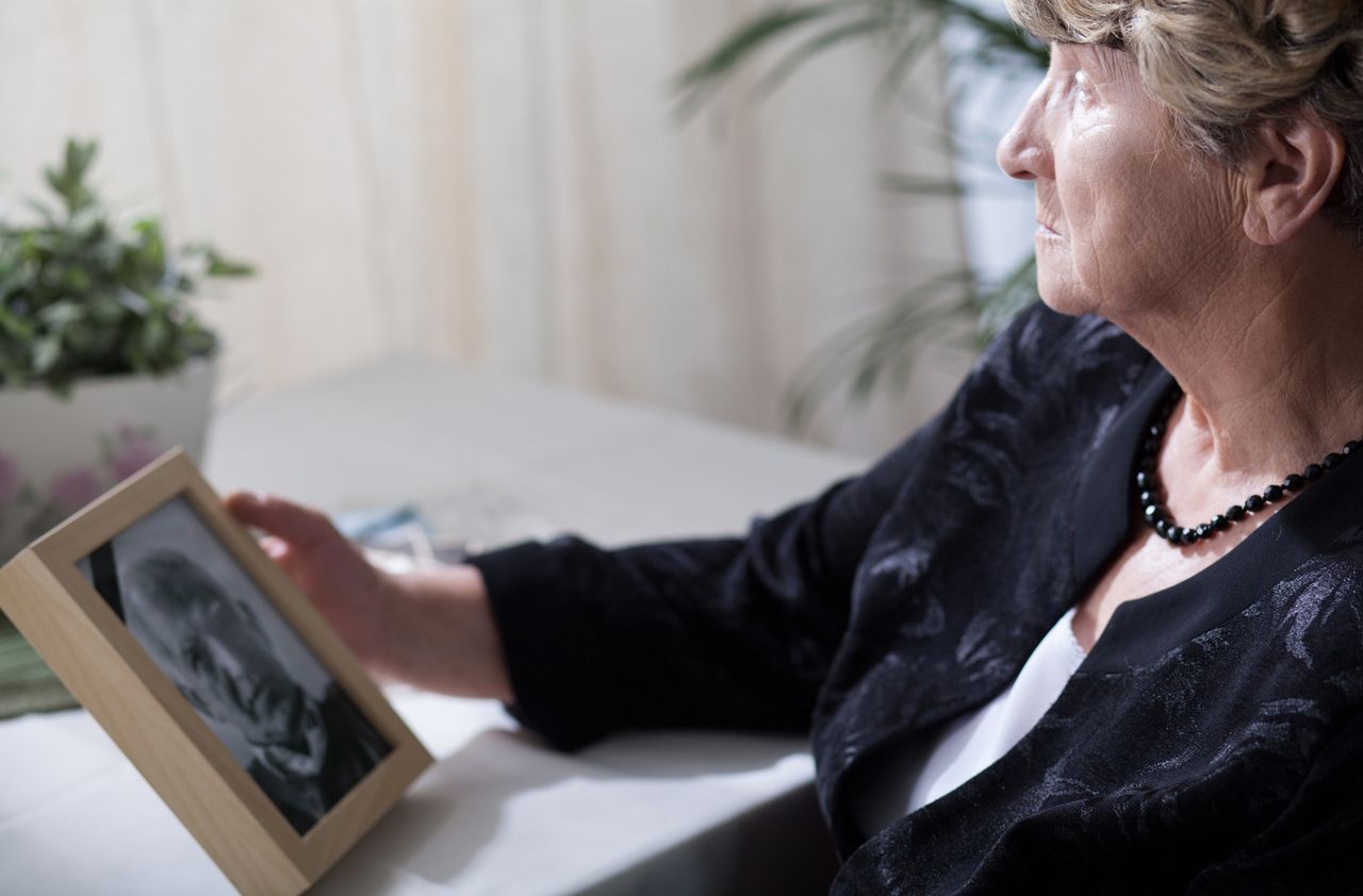 Photo of senior widow reminiscing her dead husband