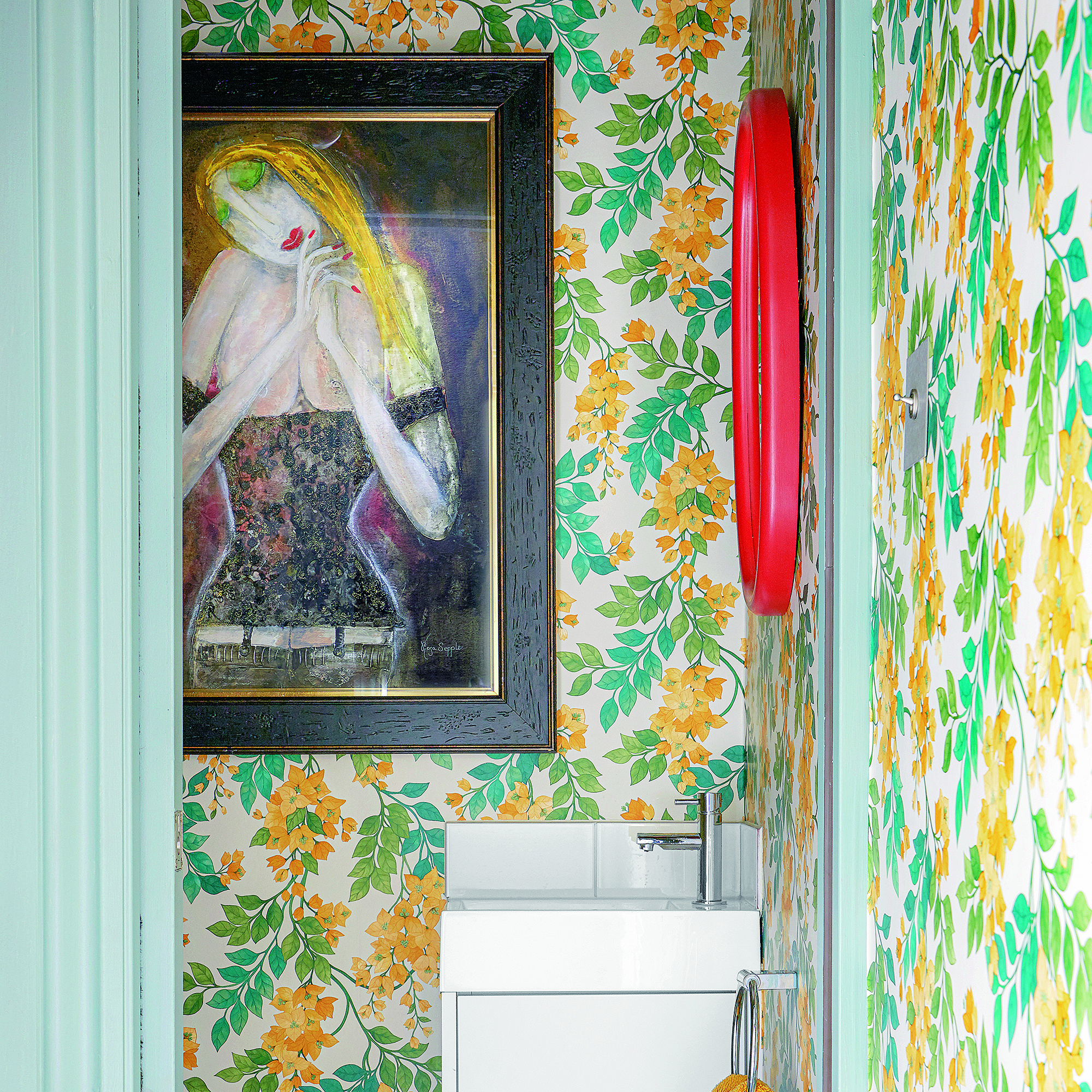 Downstairs bathroom with green and yellow wallpaper and large art print.