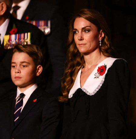 Princess Kate wearing a black dress standing next to Prince George, in a suit, at the Festival of Remembrance