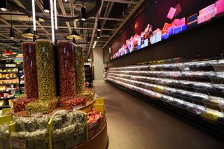 A massive dvLED display lights up the candy aisle in a grocery store.