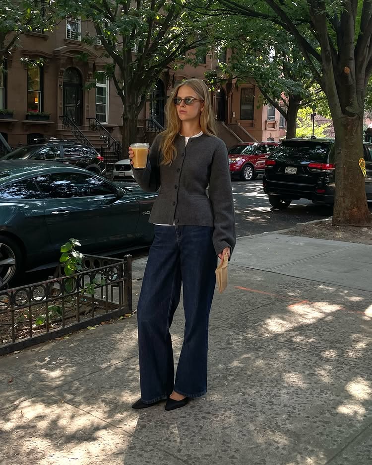 Classic Pieces 2025: @claradyrhauge wears dark indigo jeans with a grey cardigan and pointed flats