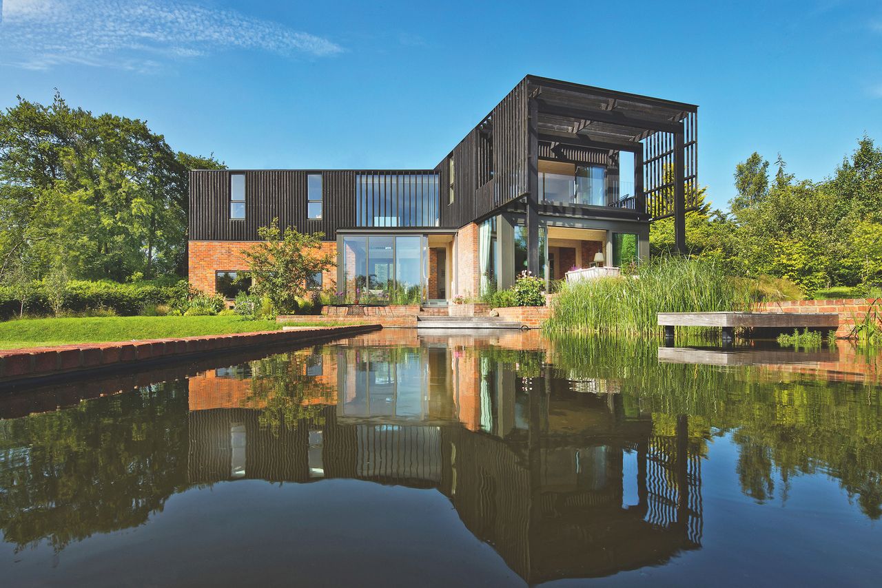 brick and timber clad self build with natural swimming pool rear