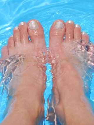 woman with feet in pool
