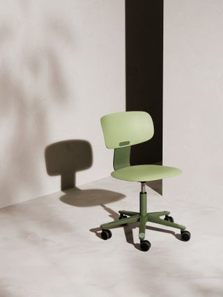 A green office chair with a low back.