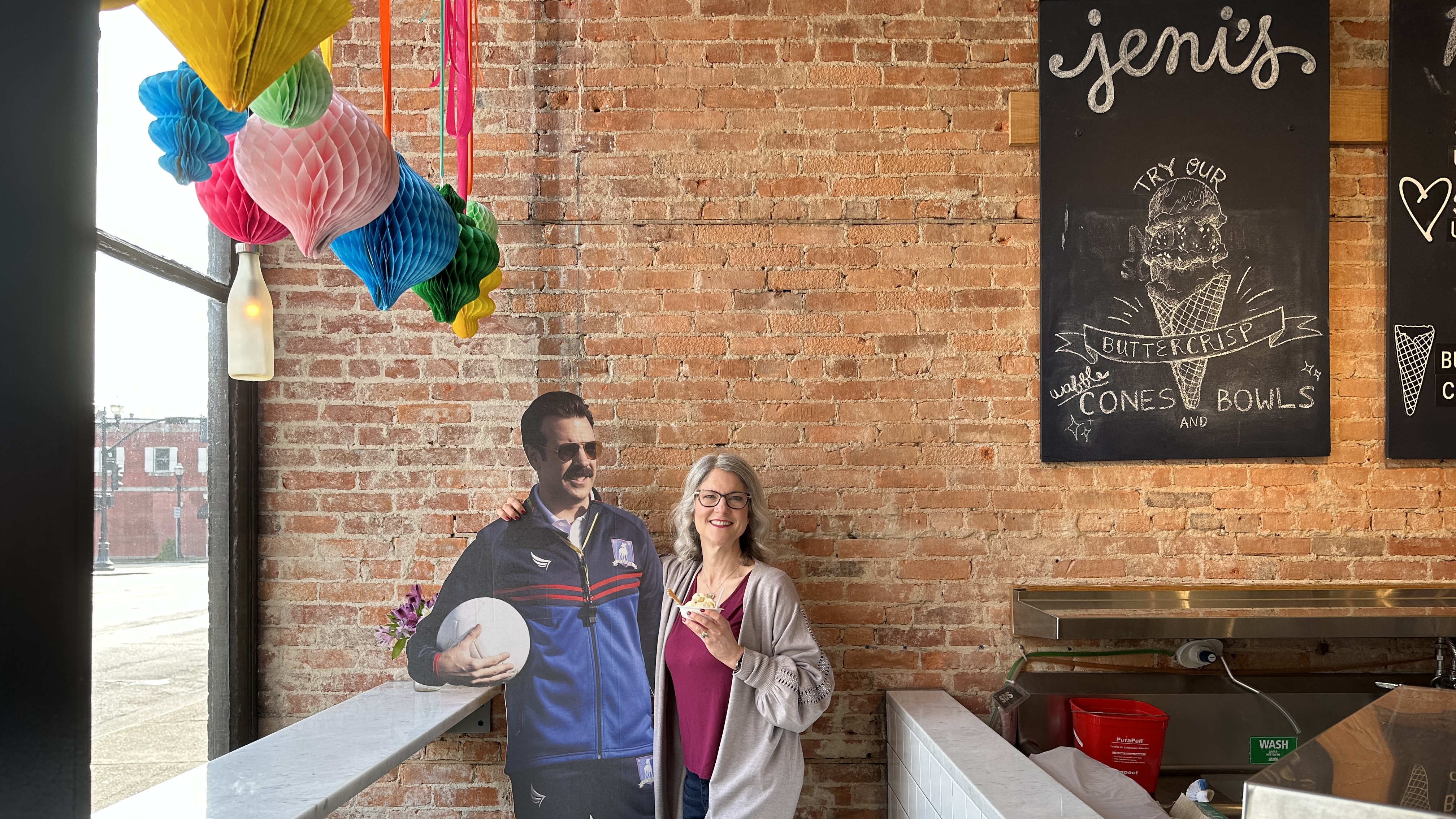 Karen and Ted Lasso posing with ice cream