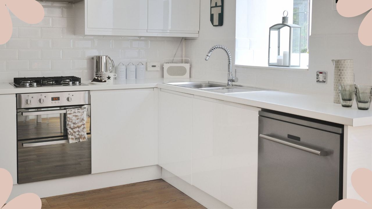 Kitchen with white cabinets and chrome appliances, there is a dishwasher to the right next to a sink and a oven in the centre of the kitchen, with a window above the sink to support the viral tin foil dishwasher hack 