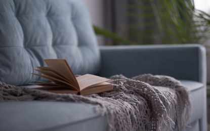 open book lying on a sofa