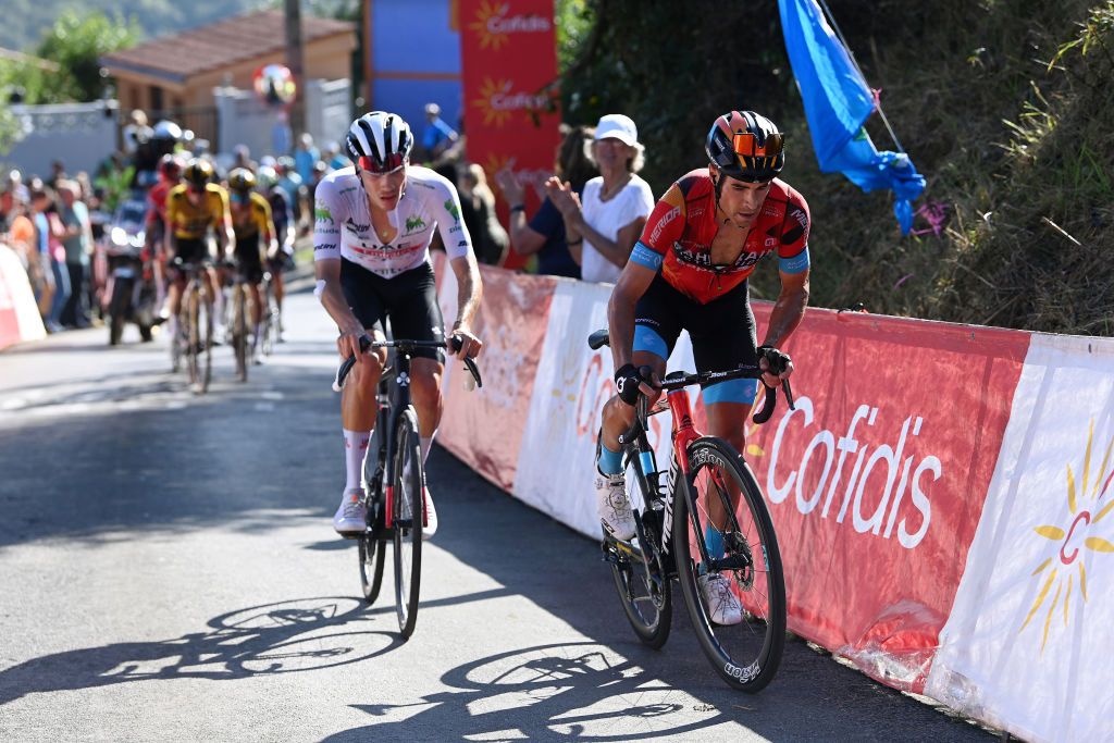 LACRUZDELINARES SPAIN SEPTEMBER 14 LR Juan Ayuso of Spain and UAE Team Emirates White best young jersey and Mikel Landa of Spain and Team Bahrain Victorious compete in the chase group climbing to the Puerto de la Cruz de Linares 840m during the 78th Tour of Spain 2023 Stage 18 a 1789km stage from Pola de Allande to La Cruz de Linares 840m UCIWT on September 14 2023 in La Cruz de Linares Spain Photo by Tim de WaeleGetty Images