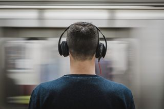 A man wearing headphones on a platform