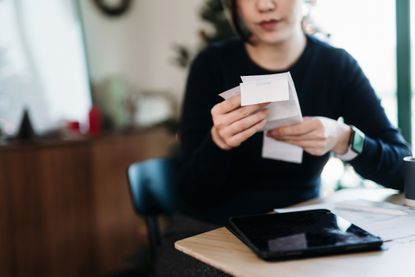 Woman looking at household bills