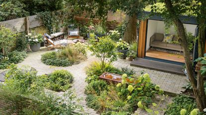 landscaping ideas with paving, planting and garden building