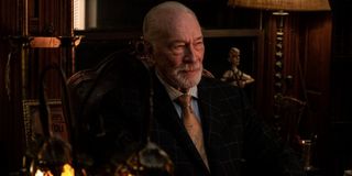 Knives Out Christopher Plummer sits, well dressed, in his study