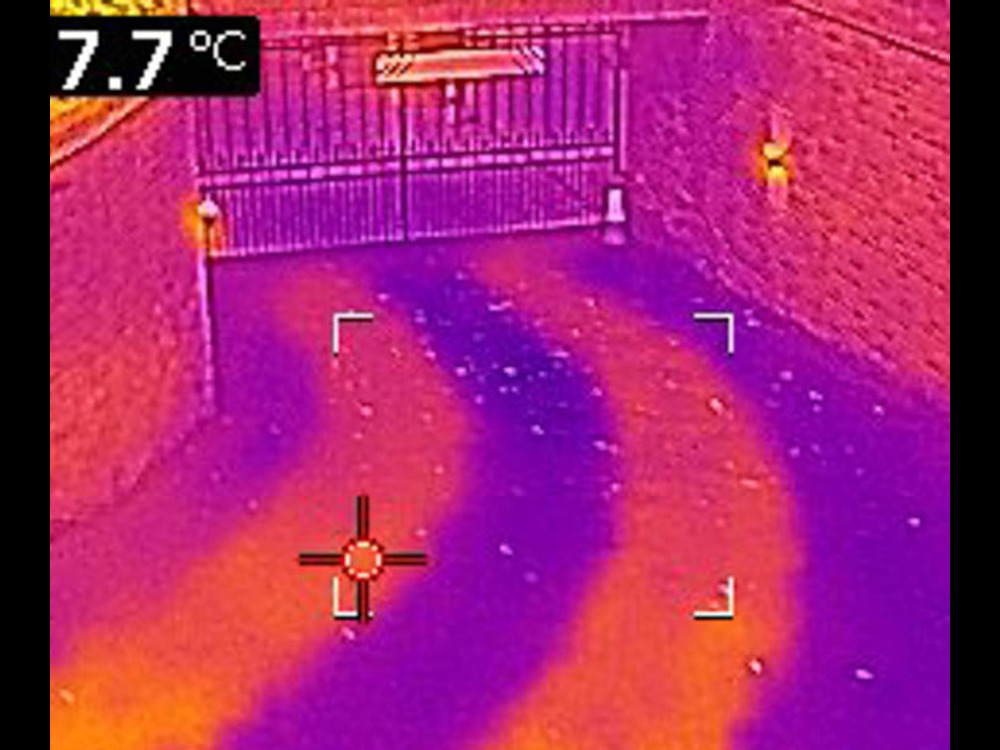 An infrared image of a Heated Driveway Systems installation. The imaging technology shows how heating is provided in track form, which manages the costs of installation and heating.