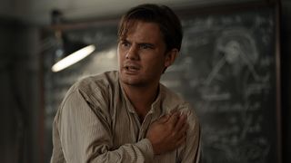 Jeremy Irvine as Henry in Outlander: Blood of My Blood clutching his chest and looking shocked. 
