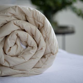 Wool duvet folded up on bed