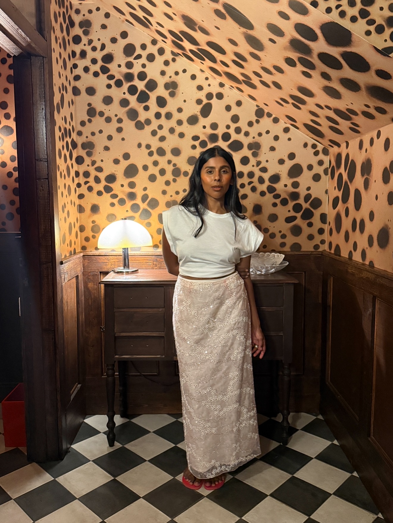 An image of @monikh wearing a white t-shirt with a sequin skirt, one of the key autumn London fashion trends 2025.