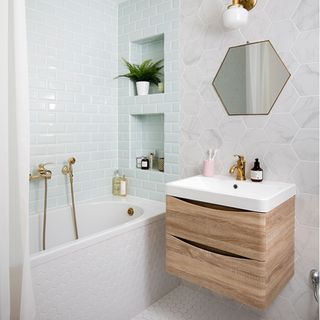 white bathroom with shower bath and wall hung storage