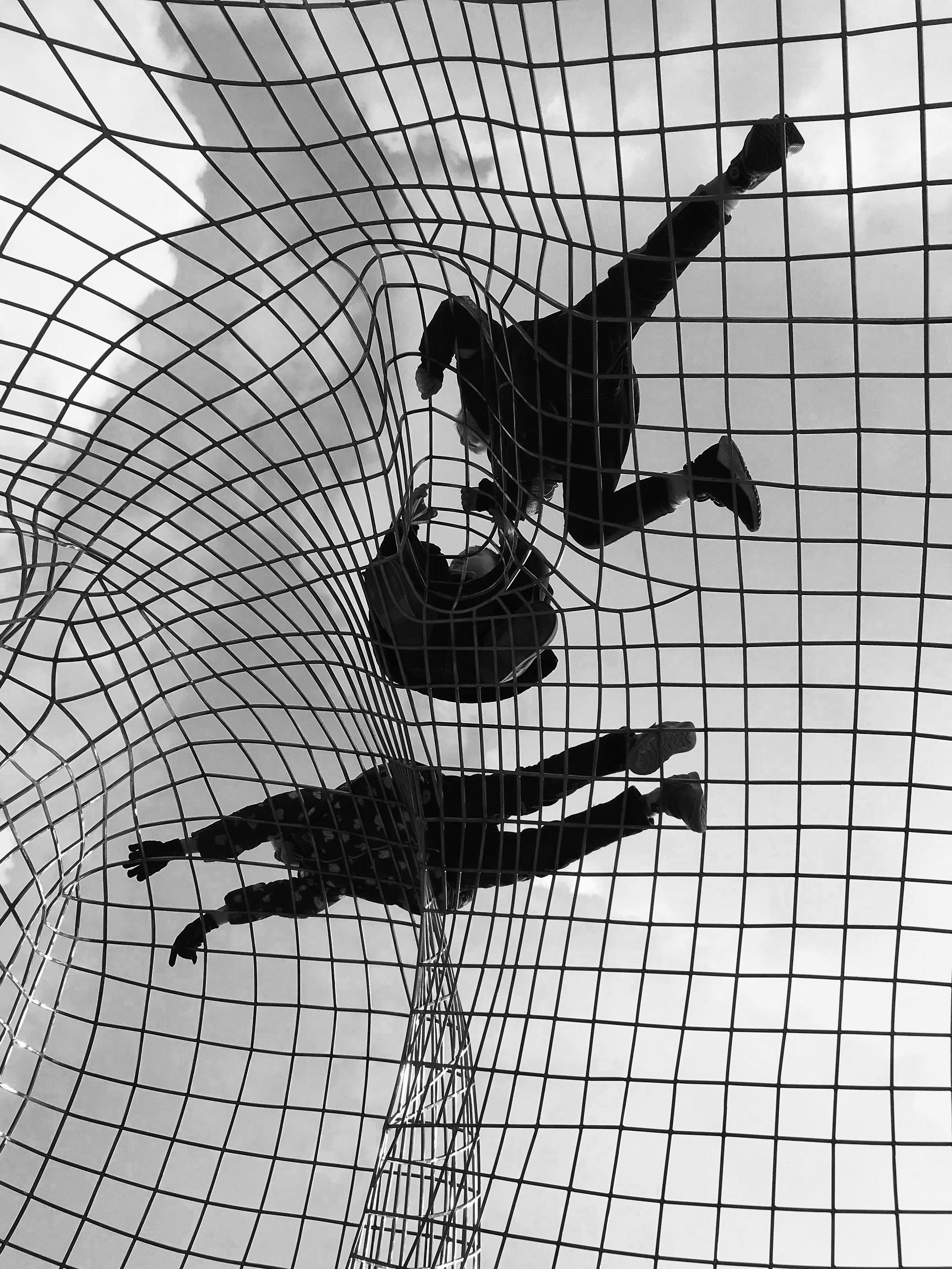 Untitled shot of kids playing in some netting for the iPhone Photography Awards 2021