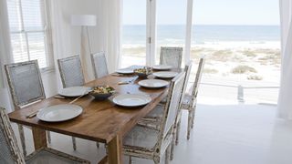 A dining room in the coastal style overlooking a beach