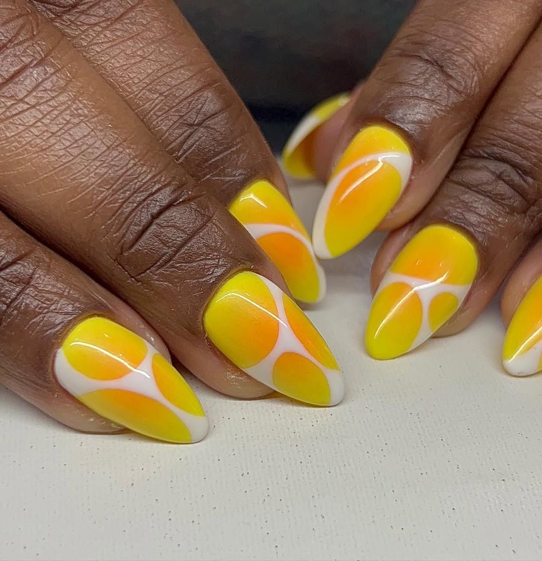 Yellow and orange aura ombré nails with white lines.