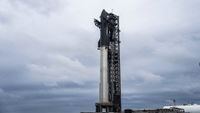 A silver stainless-steel SpaceX Starship is assembled for launch on the pad for Flight 7.