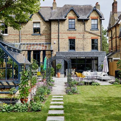 house exterior with brick walls and lawn area