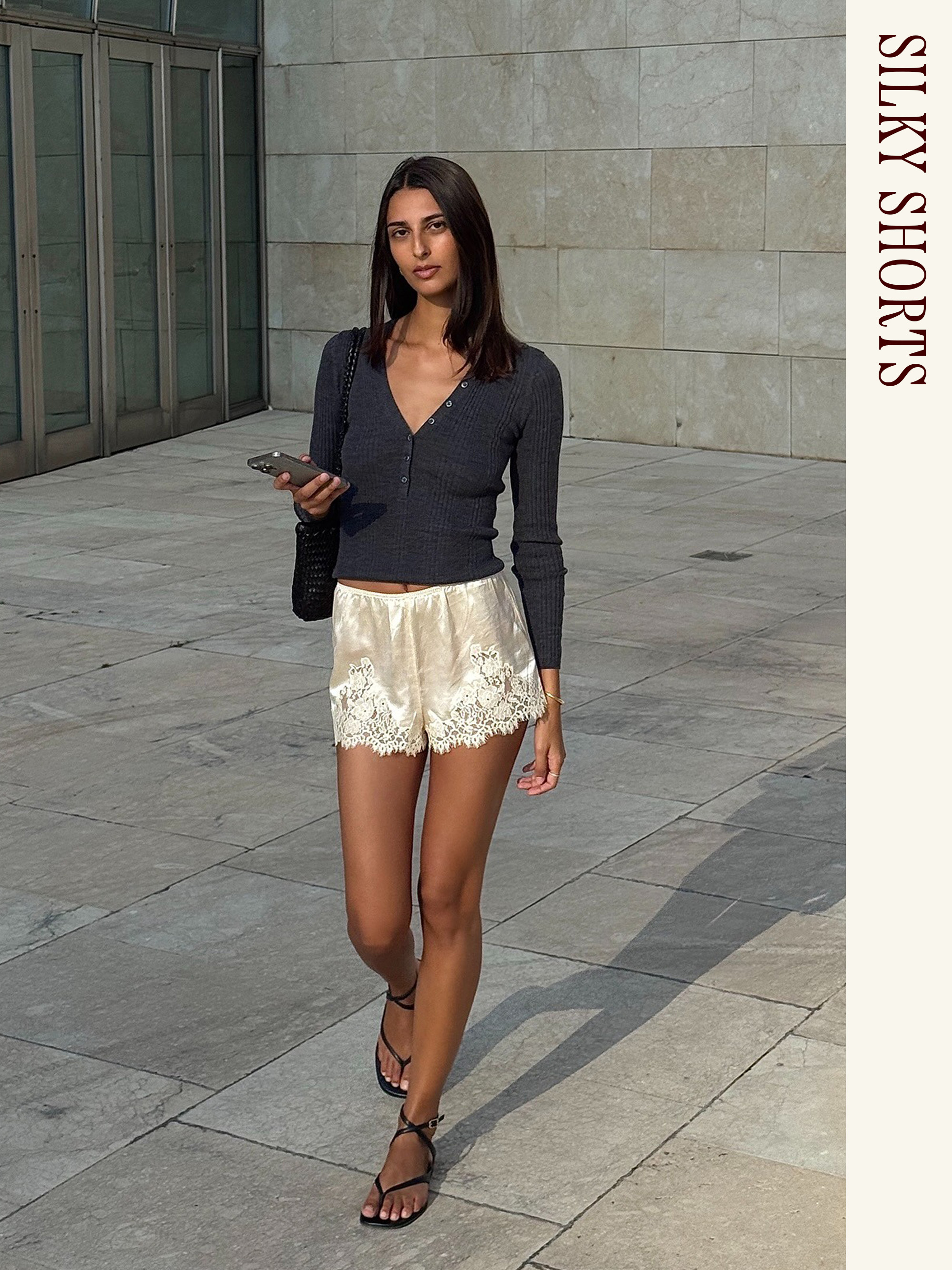 Influencer wearing a black cardigan and Doen satin shorts