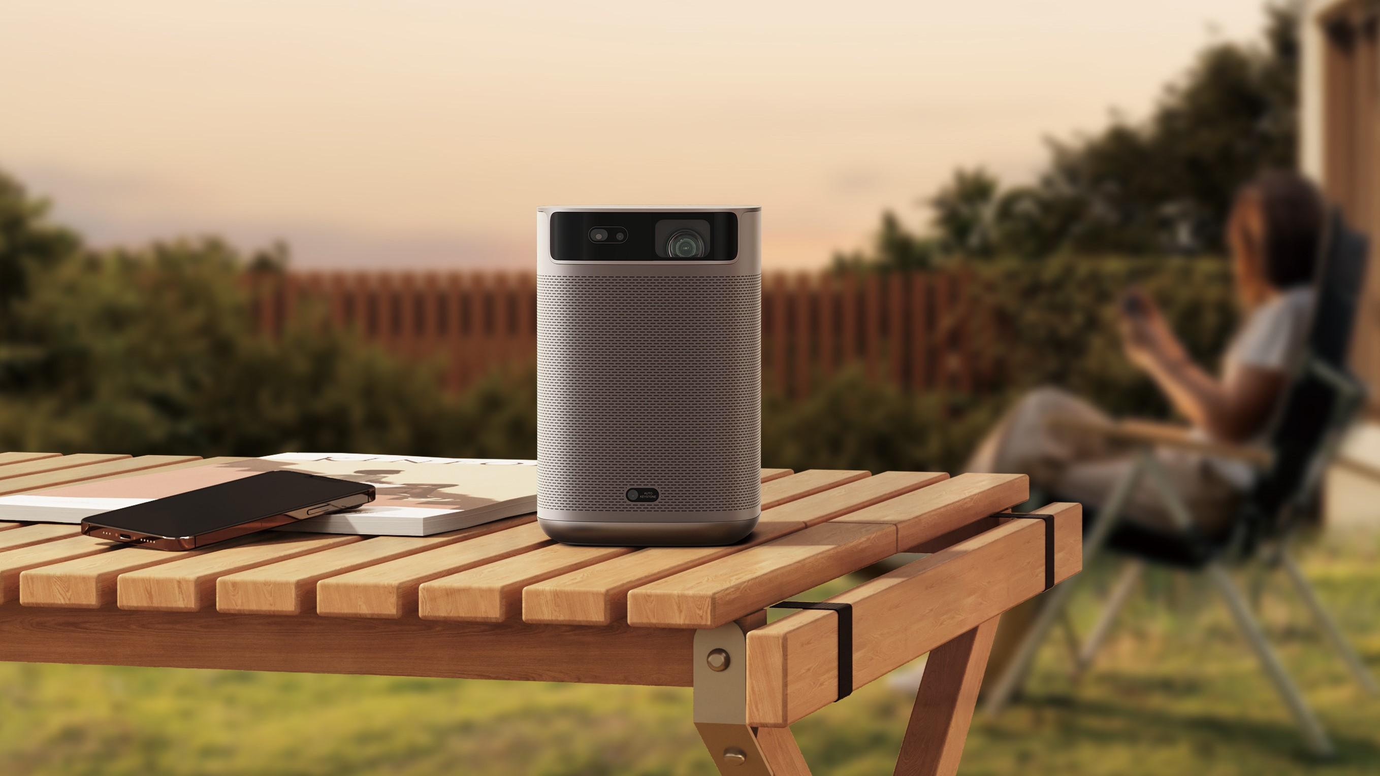Xgimi MoGo 2 Pro on table outdoors with trees in the background