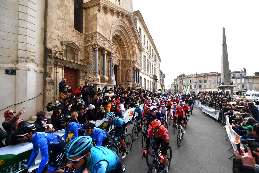 MANOSQUE FRANCE FEBRUARY 12 A general view of the peloton passing in front of the Church of St Trophimus on its departure in the city of Arles while fans cheer during the 6th Tour de La Provence 2022 Stage 2 a 1806km stage from Arles to Manosque 417m TDLP22 on February 12 2022 in Manosque France Photo by Luc ClaessenGetty Images