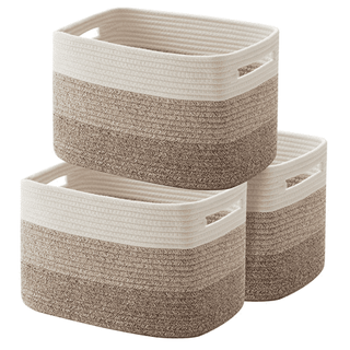 Three woven baskets, tri color going from dark brown at the bottom, to light brown, to cream at the top. Stacked with two baskets on the bottom and one on top. white background