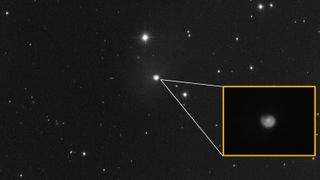 Photo of comet with a close-up of its coma showing off a distinctive spiral shape