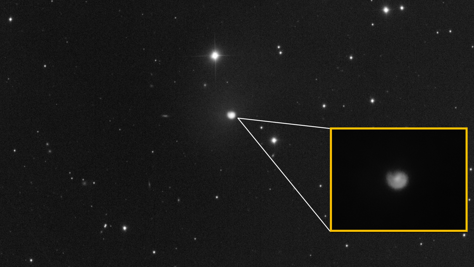 Photo of comet with a close-up of its coma showing off a distinctive spiral shape