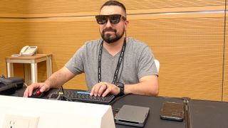 A person using the Khadas Mind 2S mini PC with AR glasses at a desk