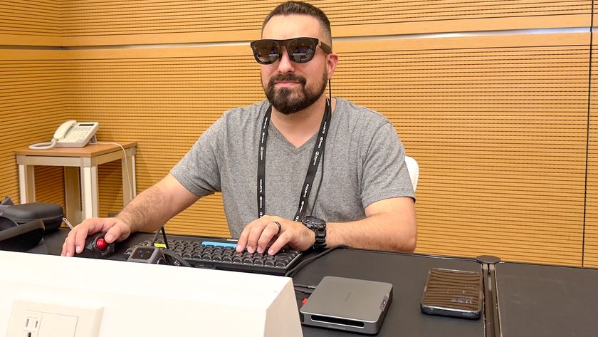 A person using the Khadas Mind 2S mini PC with AR glasses at a desk