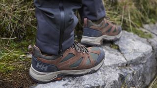 Person's feet wearing Helly Hansen Switchback low-cut Trail HT hiking shoes