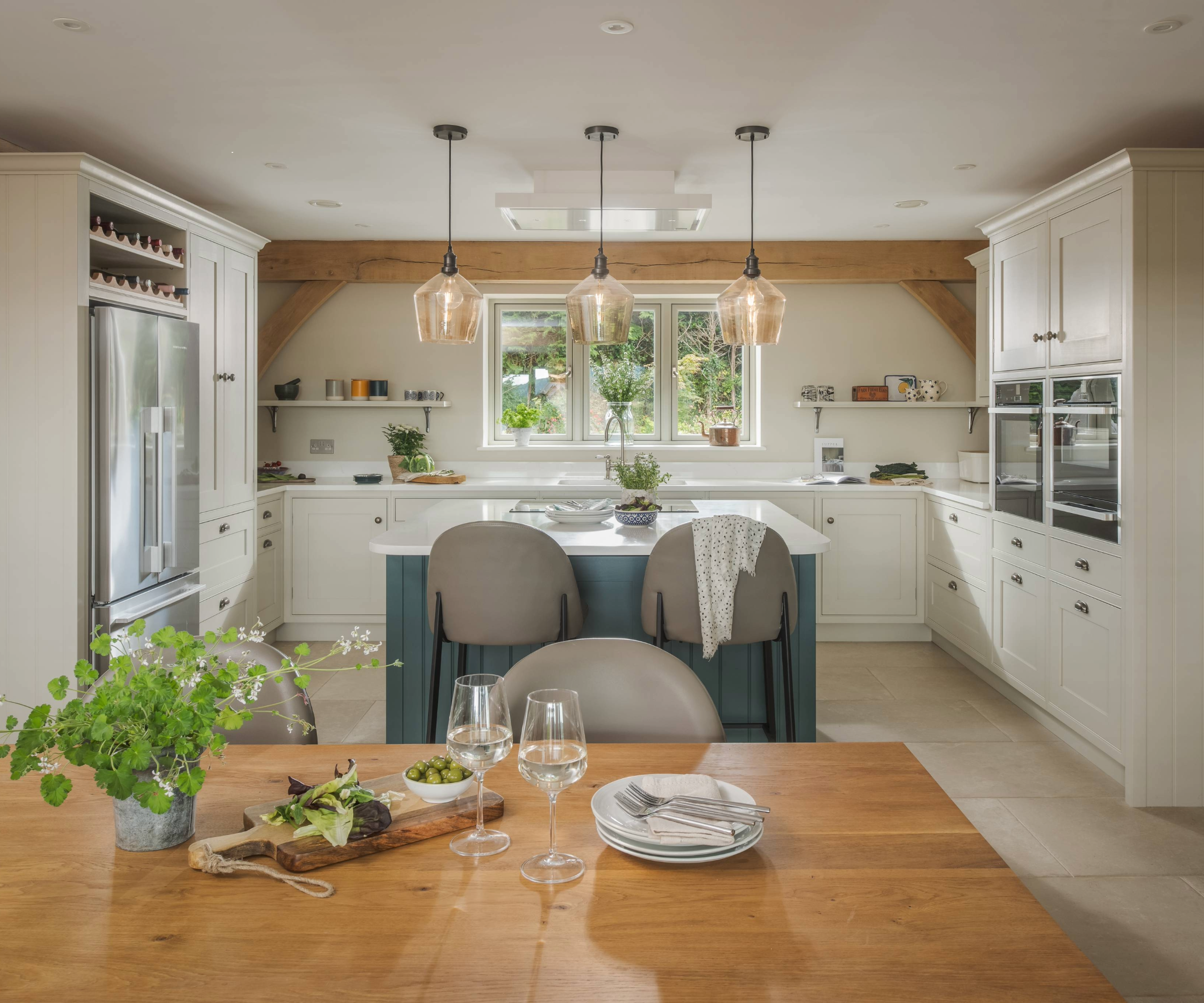 Kitchen featuring a dining table, white cabinets, and a central island