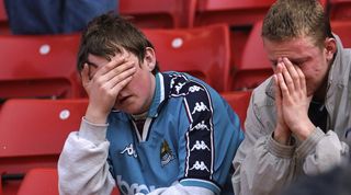 Manchester City fans react after their club is relegated to League Two in May 1998.