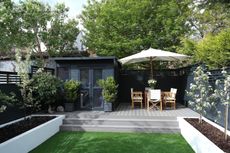 Parasol deal: Decking ideas with raised grey decked area from Ecodek